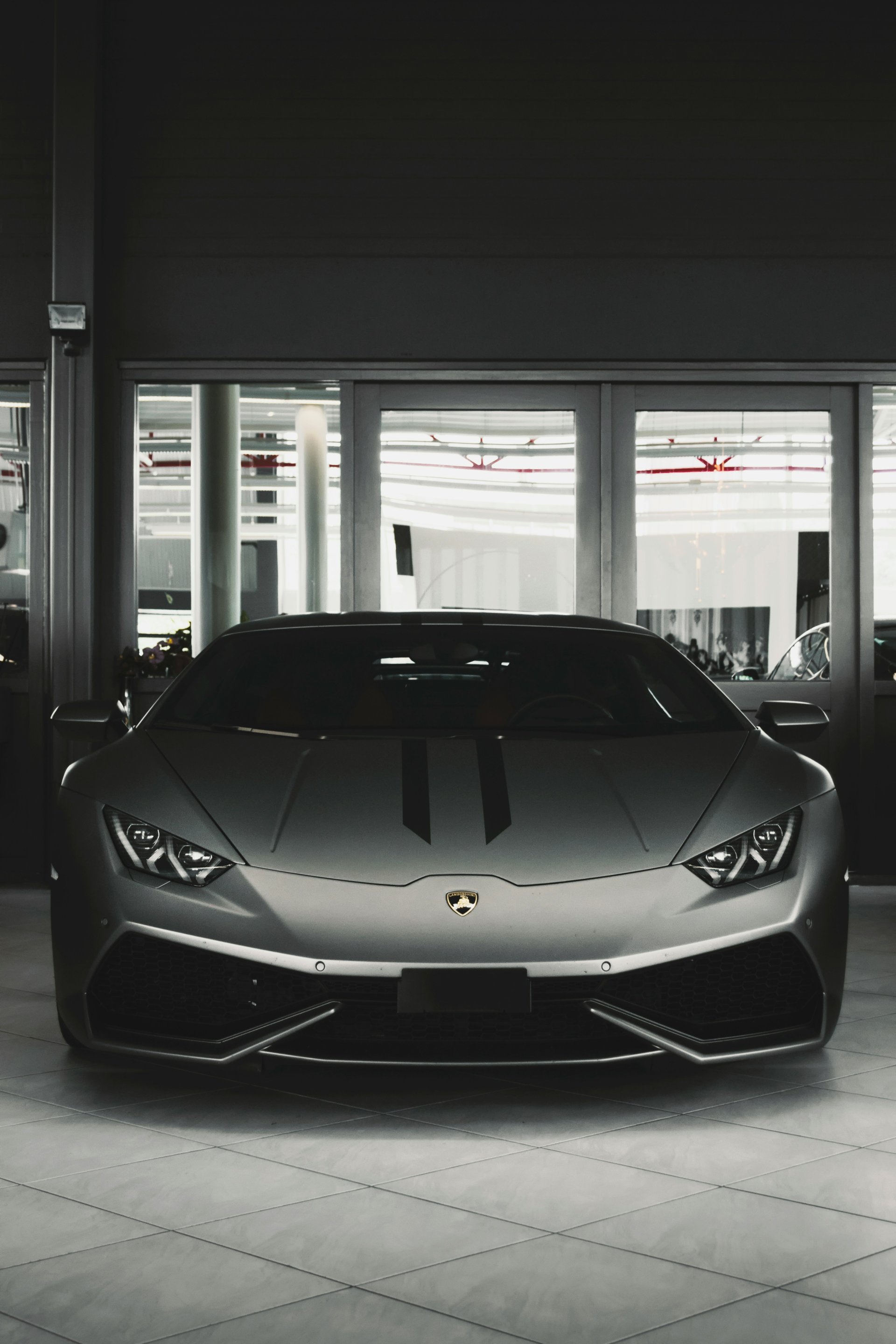 Silver Lamborghini Huracán in luxury showroom