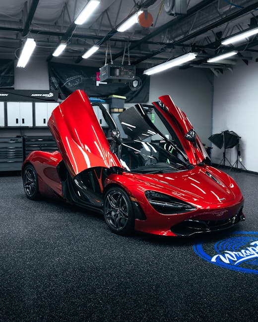 Vermillion red McLaren 720S with gullwing doors open in studio