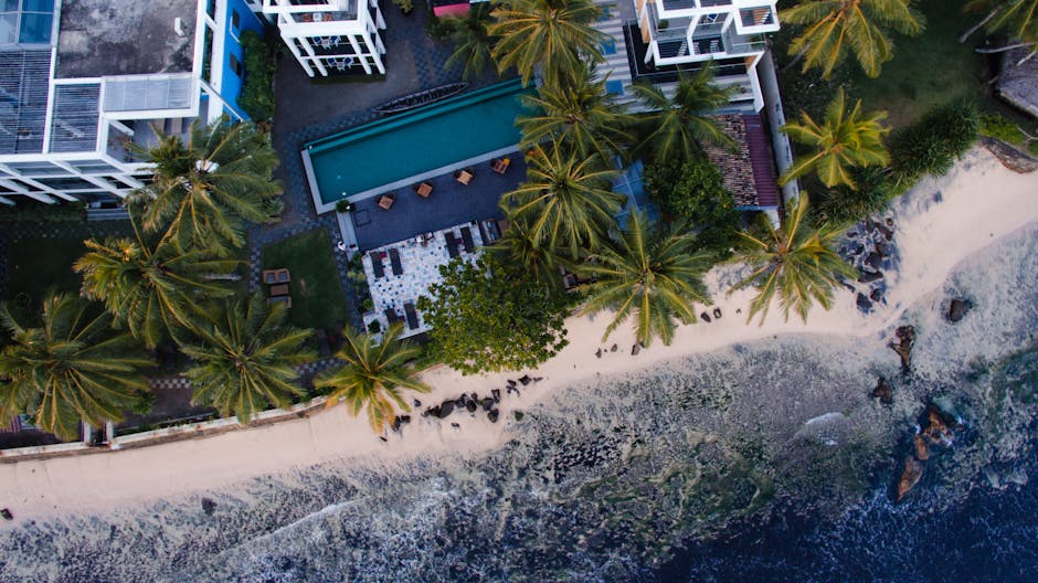 Luxury beachfront resort with turquoise pool and white architecture