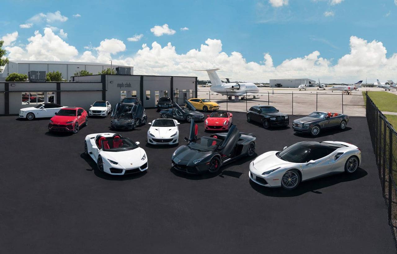 Premium exotic car lineup featuring Ferraris, Lamborghinis, and McLarens at luxury facility